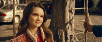 Movie still from “Cherry” (2021), directed by Joe Russo – A woman in a red jacket standing in front of a tree; Close Up shot, Over the shoulder angle