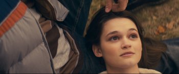 Movie still from “Cherry” (2021), directed by Joe Russo – A person laying on the ground; Close Up shot, Overhead angle