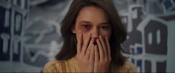 Movie still from “Cherry” (2021), directed by Joe Russo – A young woman covers her face with her hands; Close Up shot, Over the shoulder angle