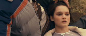 Movie still from “Cherry” (2021), directed by Joe Russo – A person laying on the ground; Close Up shot, Over the shoulder angle