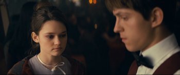 Movie still from “Cherry” (2021), directed by Joe Russo – A young woman and a young man sitting next to each other; Close Up shot, Over the shoulder angle