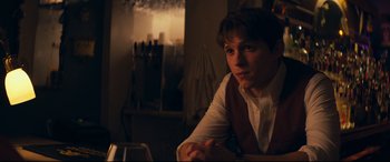 Movie still from “Cherry” (2021), directed by Joe Russo – A man sitting at a table in front of candles; Close Up shot, Over the shoulder angle