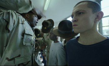 Movie still from “Cherry” (2021), directed by Joe Russo – A group of men standing next to each other on top of a train; Close Up shot, Over the shoulder angle