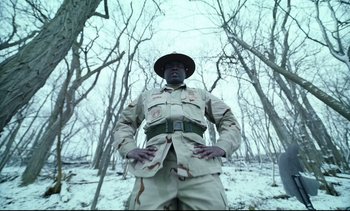 Movie still from “Cherry” (2021), directed by Joe Russo – A man in a uniform standing in the snow; Medium shot, Low angle