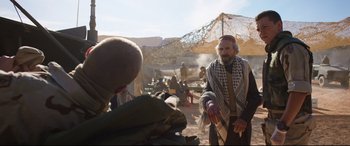 Movie still from “Cherry” (2021), directed by Joe Russo – An old man is talking to an older man outside; Medium shot, Over the shoulder angle