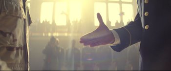 Movie still from “Cherry” (2021), directed by Joe Russo – A man reaching out his hand to a crowd of onlookers; Extreme Close Up shot, Low angle