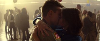 Movie still from “Cherry” (2021), directed by Joe Russo – A man and a woman kissing each other in front of a crowd; Close Up shot, Low angle