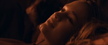 Movie still from “Cherry” (2021), directed by Joe Russo – A woman's face in the dark; Close Up shot, Overhead angle