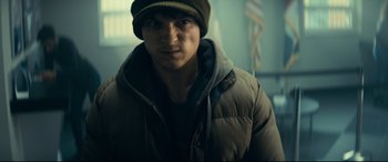 Movie still from “Cherry” (2021), directed by Joe Russo – A young man wearing a jacket and a hat; Close Up shot, Low angle