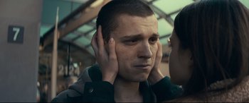 Movie still from “Cherry” (2021), directed by Joe Russo – A man with his hands covering his ears; Close Up shot, Low angle