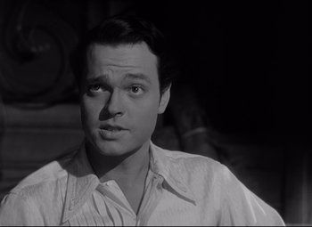 Movie still from “Citizen Kane” (1941), directed by Orson Welles – A black - and - white photo of a man looking at the camera; Close Up shot, Over the shoulder angle