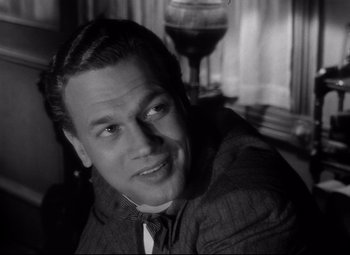 Movie still from “Citizen Kane” (1941), directed by Orson Welles – A black and white photo of a man in a suit and tie; Close Up shot, Low angle