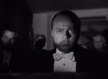 Movie still from “Citizen Kane” (1941), directed by Orson Welles – A black and white photo of a man in a tuxedo; Close Up shot, Low angle