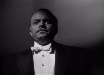 Movie still from “Citizen Kane” (1941), directed by Orson Welles – A black and white photo of a man wearing a bow tie; Close Up shot, Low angle