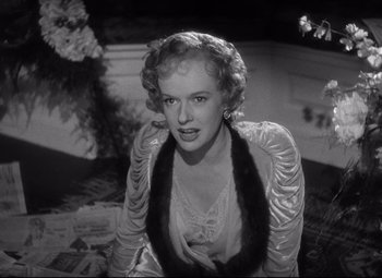 Movie still from “Citizen Kane” (1941), directed by Orson Welles – A black - and - white photo of a woman sitting on the ground; Close Up shot, Low angle