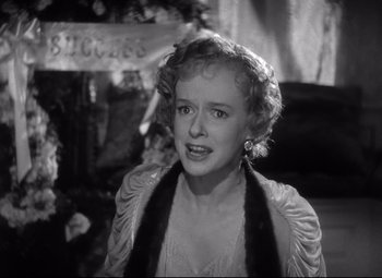 Movie still from “Citizen Kane” (1941), directed by Orson Welles – An old black and white photo of a woman; Close Up shot, Over the shoulder angle