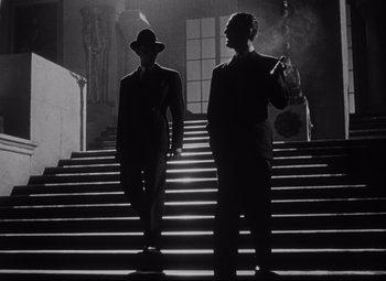 Movie still from “Citizen Kane” (1941), directed by Orson Welles – Two men are walking down a set of stairs; Medium shot, Low angle
