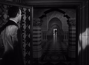 Movie still from “Citizen Kane” (1941), directed by Orson Welles – A black and white photo of a man and a woman in an ornate room; Wide shot, Over the shoulder angle
