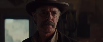 Movie still from “Cowboys & Aliens” (2011), directed by Jon Favreau – A person wearing a hat; Close Up shot, Over the shoulder angle