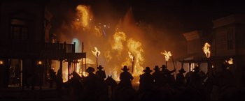Movie still from “Cowboys & Aliens” (2011), directed by Jon Favreau – A group of people riding horses through a fire; Wide shot, Low angle