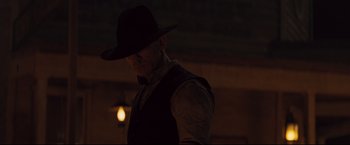 Movie still from “Cowboys & Aliens” (2011), directed by Jon Favreau – A man wearing a black hat and a vest; Medium shot, Low angle