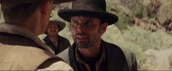 Movie still from “Cowboys & Aliens” (2011), directed by Jon Favreau – A person wearing a hat; Close Up shot, Over the shoulder angle