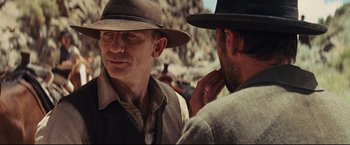 Movie still from “Cowboys & Aliens” (2011), directed by Jon Favreau – A man in a hat talking to another man in a hat; Close Up shot, Over the shoulder angle