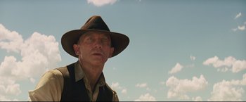 Movie still from “Cowboys & Aliens” (2011), directed by Jon Favreau – A man wearing a hat and a jacket; Close Up shot, Low angle