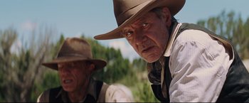 Movie still from “Cowboys & Aliens” (2011), directed by Jon Favreau – A man in a cowboy hat looking at the camera; Close Up shot, Low angle
