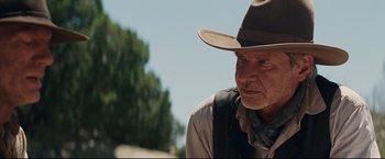 Movie still from “Cowboys & Aliens” (2011), directed by Jon Favreau – An older man wearing a cowboy hat and vest; Close Up shot, Over the shoulder angle