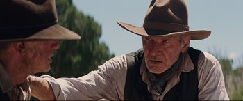 Movie still from “Cowboys & Aliens” (2011), directed by Jon Favreau – An older man wearing a cowboy hat and vest; Close Up shot, Over the shoulder angle