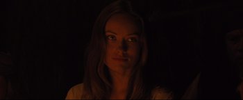 Movie still from “Cowboys & Aliens” (2011), directed by Jon Favreau – A woman with long brown hair stares at the camera; Close Up shot, Over the shoulder angle