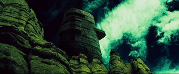 Movie still from “Cowboys & Aliens” (2011), directed by Jon Favreau – A very tall building on top of a mountain; Extreme Wide shot, Low angle