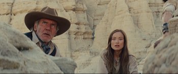 Movie still from “Cowboys & Aliens” (2011), directed by Jon Favreau – A man and a woman are standing in front of a cliff; Close Up shot, Low angle