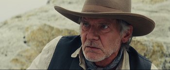 Movie still from “Cowboys & Aliens” (2011), directed by Jon Favreau – An older man wearing a cowboy hat looking at the camera; Close Up shot, Over the shoulder angle