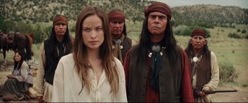 Movie still from “Cowboys & Aliens” (2011), directed by Jon Favreau – A group of people standing next to each other in a field; Medium shot, Over the shoulder angle