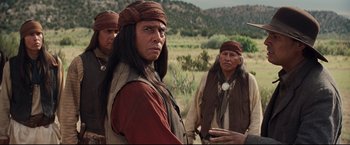 Movie still from “Cowboys & Aliens” (2011), directed by Jon Favreau – A group of native american men standing in a field; Medium shot, Over the shoulder angle