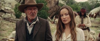 Movie still from “Cowboys & Aliens” (2011), directed by Jon Favreau – A man and a woman standing next to each other in a field; Close Up shot, Over the shoulder angle