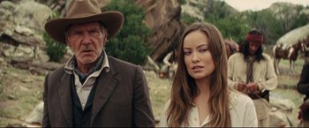 Movie still from “Cowboys & Aliens” (2011), directed by Jon Favreau – A man and a woman standing next to each other in a field; Close Up shot, Over the shoulder angle