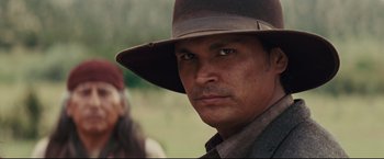 Movie still from “Cowboys & Aliens” (2011), directed by Jon Favreau – A person wearing a hat; Close Up shot, Over the shoulder angle