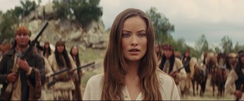 Movie still from “Cowboys & Aliens” (2011), directed by Jon Favreau – A woman with long brown hair standing in front of a group of people; Close Up shot, Over the shoulder angle