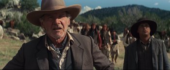 Movie still from “Cowboys & Aliens” (2011), directed by Jon Favreau – An old man in a cowboy hat is looking at a crowd of people; Close Up shot, Low angle