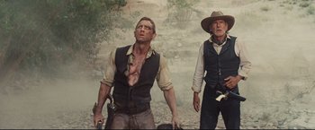 Movie still from “Cowboys & Aliens” (2011), directed by Jon Favreau – A man and an older man in a cowboy outfit; Medium shot, Low angle