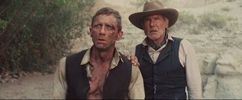 Movie still from “Cowboys & Aliens” (2011), directed by Jon Favreau – A man and an older man in a cowboy hat; Close Up shot, Low angle