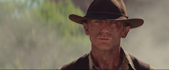 Movie still from “Cowboys & Aliens” (2011), directed by Jon Favreau – A person wearing a hat; Close Up shot, Over the shoulder angle