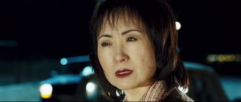 Movie still from “Crash” (2004), directed by Paul Haggis – A person wearing a scarf; Close Up shot, Low angle