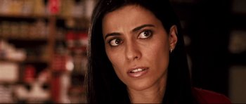 Movie still from “Crash” (2004), directed by Paul Haggis – A person with long black hair; Close Up shot, Over the shoulder angle