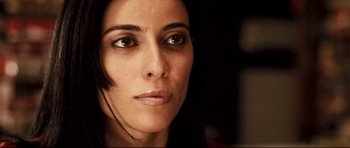 Movie still from “Crash” (2004), directed by Paul Haggis – A woman's face in a dark room; Close Up shot, Low angle