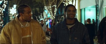 Movie still from “Crash” (2004), directed by Paul Haggis – Two men walking down a street at night; Medium shot, Over the shoulder angle