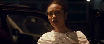 Movie still from “Crash” (2004), directed by Paul Haggis – A person wearing a white dress; Close Up shot, Over the shoulder angle